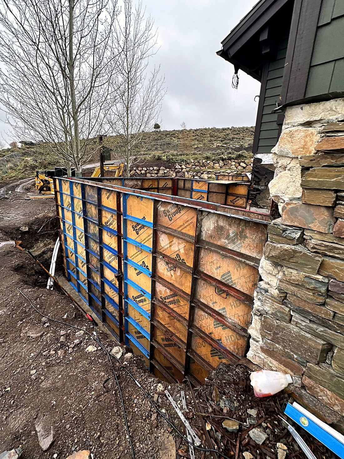 Precision concrete forms against a stone home in Park City, Utah